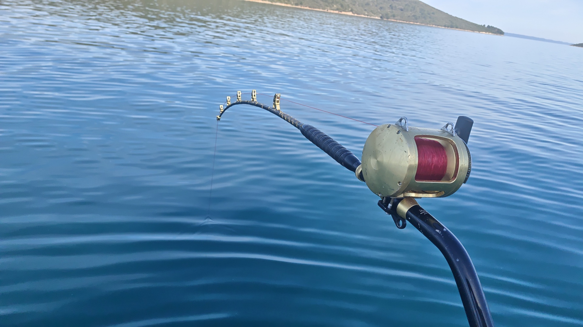 Heavy stand-up rod doubled over on a hookup off Zadar
